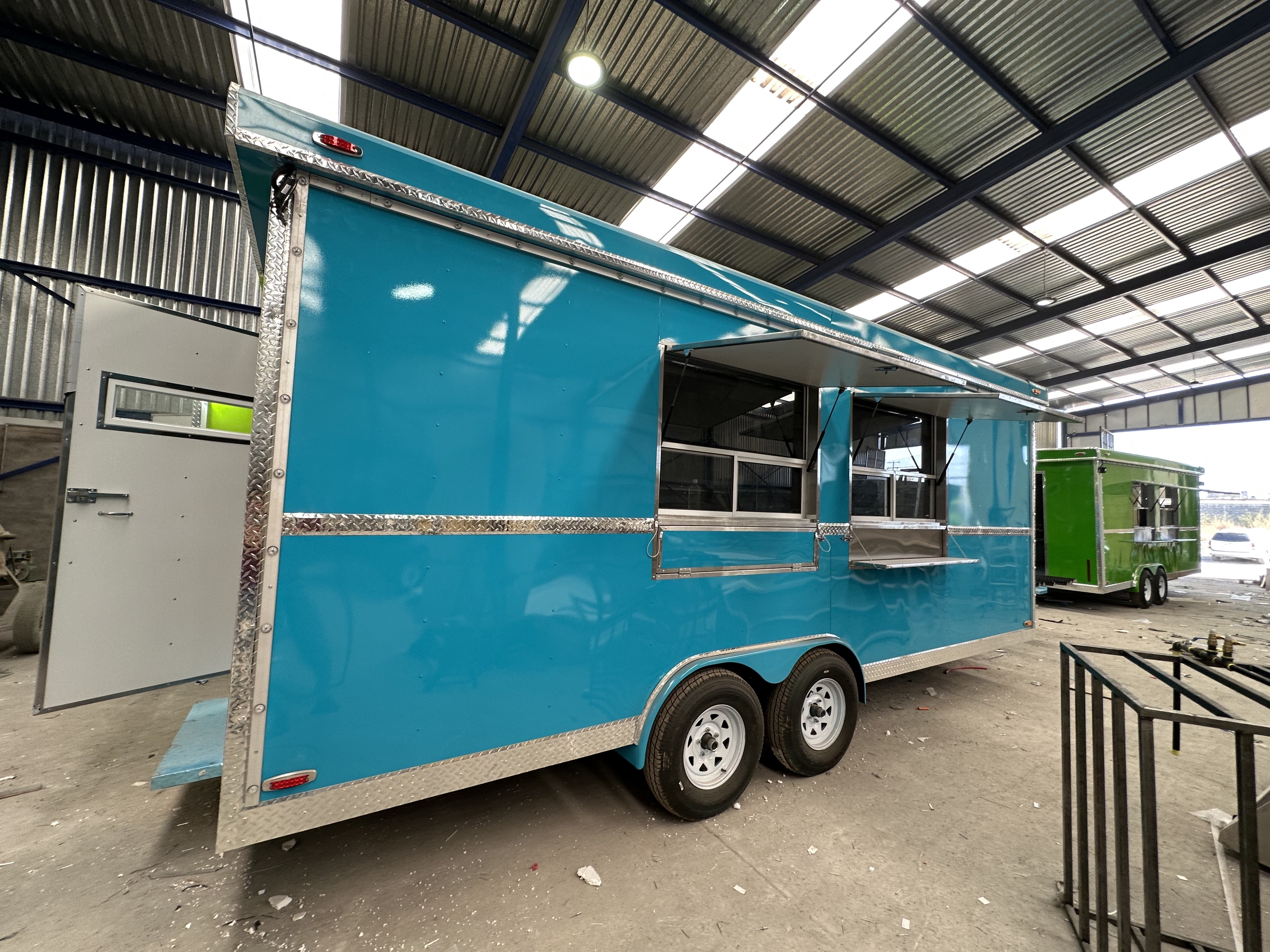 Side view of custom-built food trailer with serving window open