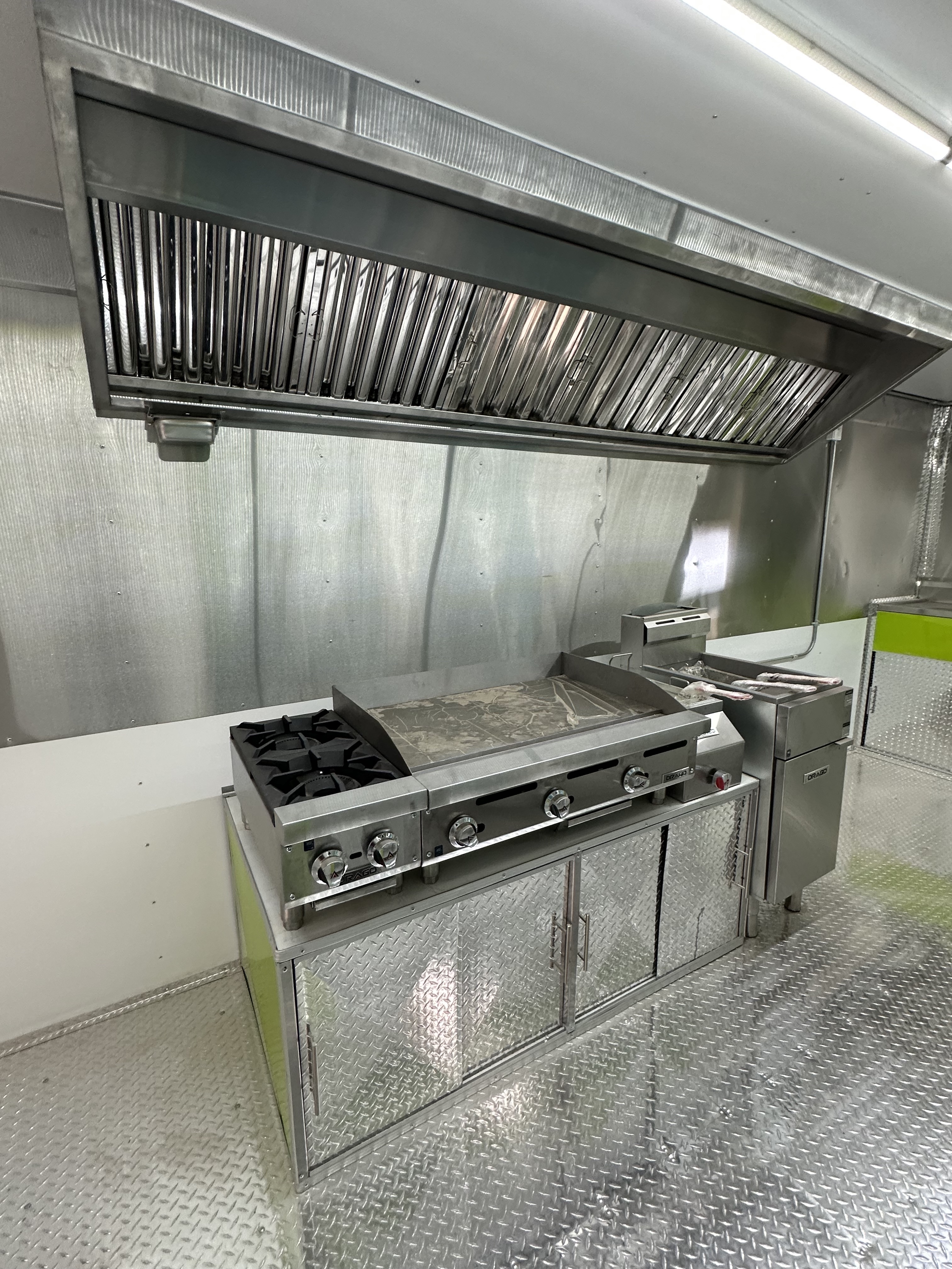 Commercial sink and stainless prep area inside food trailer