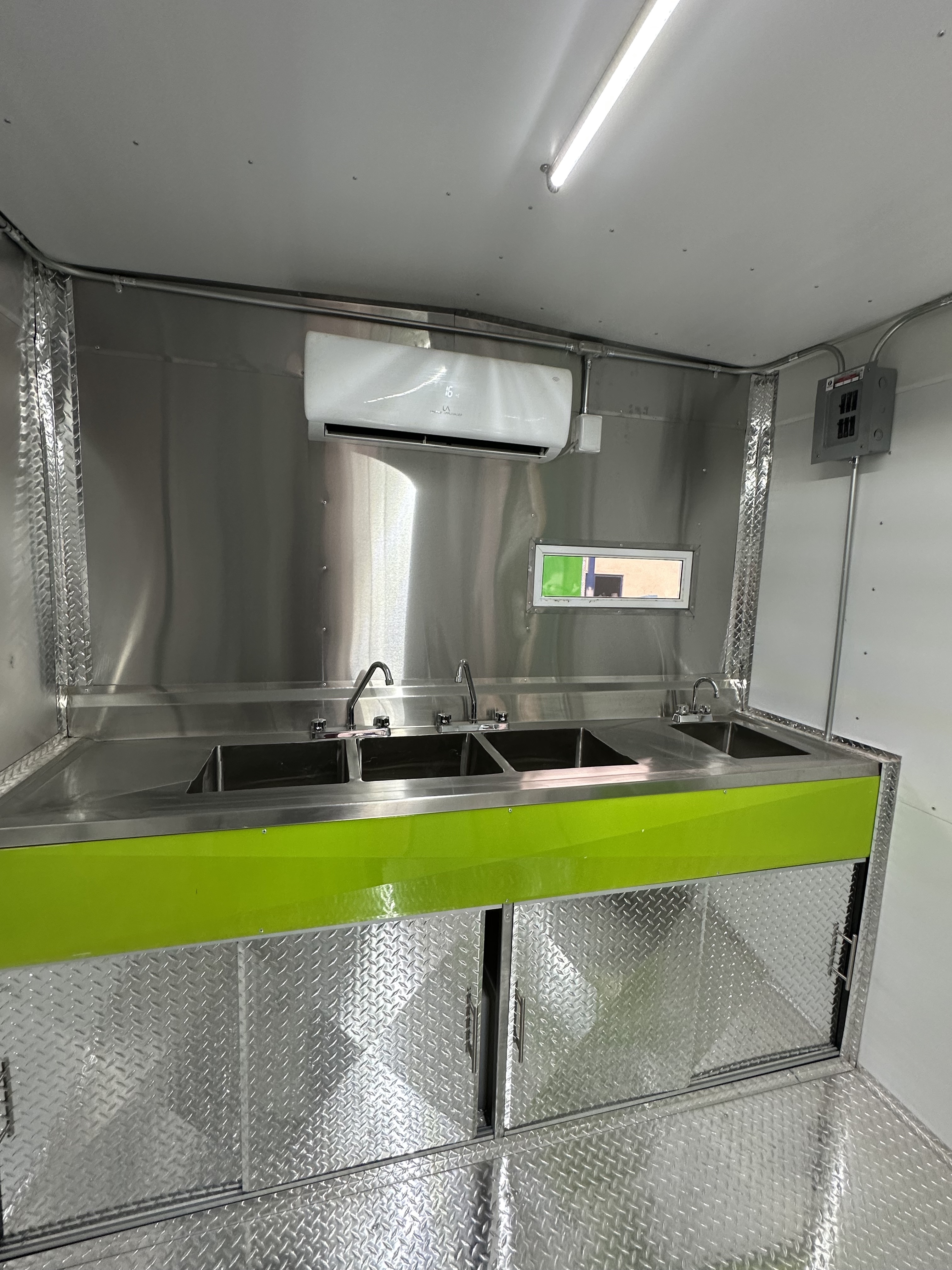 Exhaust hood and cooking line in stainless steel trailer kitchen