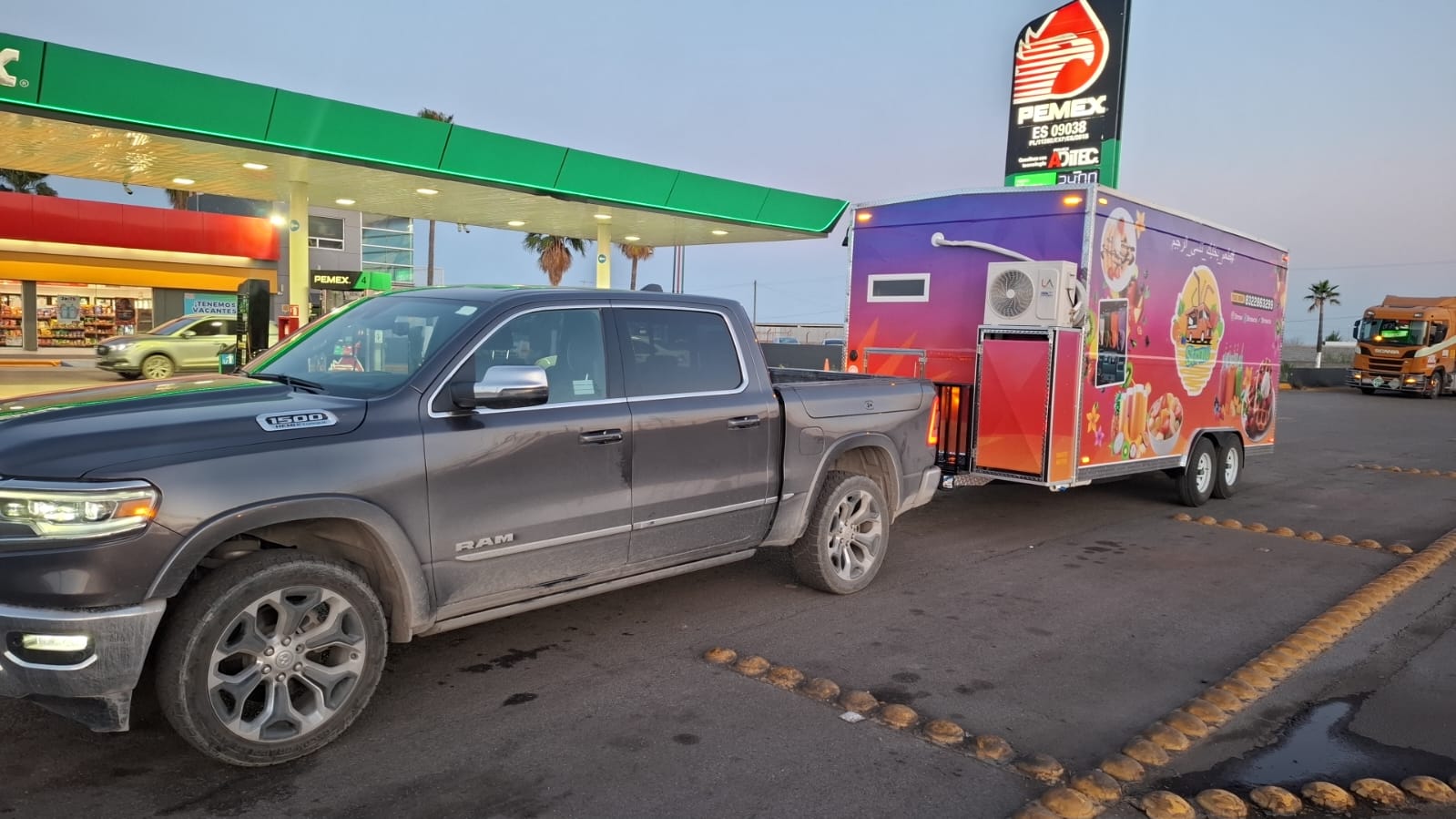 Finished food trailer hitched to a truck on its way to delivery in the USA